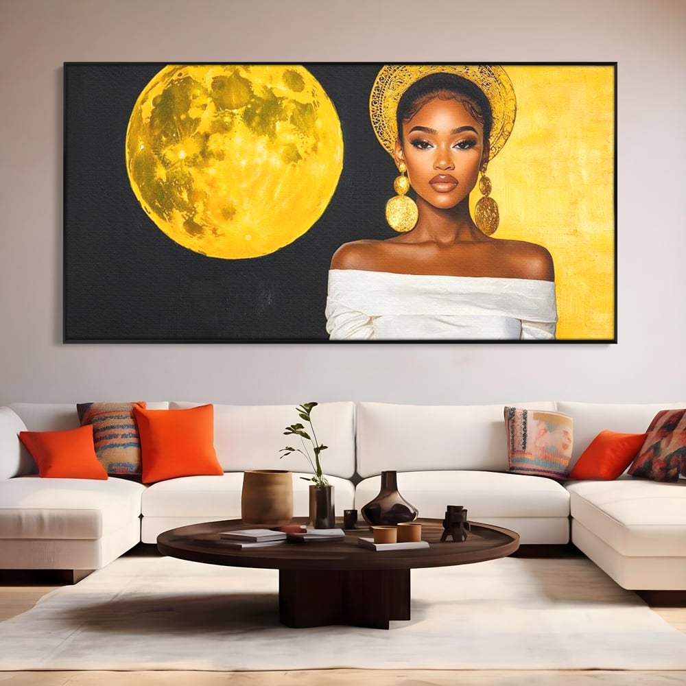 Tablou canvas cu tablou canvas cu femeie si luna aurie, in rama de aluminiu negru, pe perete intr-un living